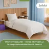 A bedroom scene with a bed made with white bedding. Produktbild-Vorschau