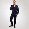 A man wearing a navy blue Lacoste tracksuit. Anteprima dell’immagine prodotto