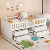 A white wooden children's bed with drawers and a railing, set up in a room with a colorful rug and wall decorations. Anteprima dell’immagine prodotto