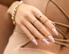 A close-up shot of a woman's hand with manicured nails and jewelry. Náhled obrázku produktu