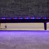 Close-up view of the underside of a sofa with LED strip lights and a power cord. Produktbild-Vorschau