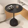 A black side table with a tissue box and a glass of water on it, next to a white sofa. Podgląd zdjęcia produktu