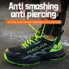 A person is tying the laces of a black and green work shoe. Produktbild-Vorschau