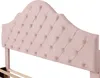 Close-up of a pink velvet tufted headboard with a scalloped shape, attached to a wooden bed frame. Produktbild-Vorschau