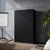 A black metal filing cabinet is shown in a modern office setting with concrete walls and wooden flooring. Voir les images du produit