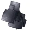 A set of black rubber car floor mats with a textured surface, arranged in a layered stack against a white background. Produktbild-Vorschau