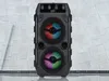 A black portable speaker with LED lights is shown in the center of the image. Podgląd zdjęcia produktu