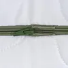 A close-up view of a zipper on a white quilted surface. Náhľad obrázku produktu