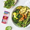 A box of sanotact EisenKomplex supplements next to a bowl of salad. Produktbild-Vorschau