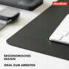 A close-up view of a desk setup with a dark gray desk mat, a keyboard, and a smartphone in the background. Anteprima dell’immagine prodotto
