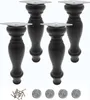 Four black wooden furniture legs with silver mounting plates are displayed against a white background. A small pile of screws and four felt pads are also visible at the bottom. Produktbild-Vorschau