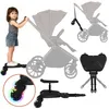 A child stands on a stroller board next to a stroller, with other components of the stroller board shown separately. Náhľad obrázku produktu
