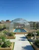 A family enjoys a covered swimming pool in a garden setting. Produktbild-Vorschau