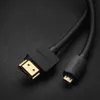 A close-up shot of a black HDMI cable with gold-plated connectors on a black textured surface. Produktbild-Vorschau