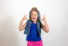 A young girl wearing headphones and a denim vest, making rock-and-roll hand gestures. Produktbild-Vorschau