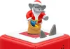 A close-up of a Christmas-themed toy elephant dressed as Santa Claus, holding a sack of gifts, standing on a red and white base with two gray shark fins protruding. Produktbild-Vorschau