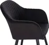 A close-up view of a black velvet armchair. Produktbild-Vorschau