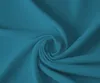 A close-up, swirled view of teal-colored fabric. Produktbild-Vorschau