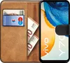 A book-style phone case with a phone, cards, and cash inside. Náhled obrázku produktu