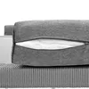 A close-up view of a gray cushion with a zipper partially open, revealing white filling. The cushion is placed on a ribbed gray surface. Produktbild-Vorschau