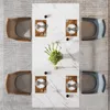 A top-down view of a dining table set for four people, with a floral centerpiece. Voir les images du produit