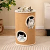 Three cats are interacting with a multi-level cat scratching post and hideaway. Produktbild-Vorschau