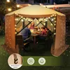 A family is enjoying a meal under a lit-up pop-up gazebo in a backyard at night. Podgląd zdjęcia produktu