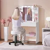 A woman is applying makeup at a vanity table with LED lights. Produktbild-Vorschau