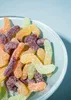 A close-up view of sour gummy worms in a bowl. Produktbild-Vorschau