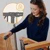 A woman is shown interacting with a baby gate installed on a staircase. Náhled obrázku produktu