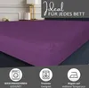 A purple fitted sheet is shown on a bed, with marketing text and icons at the top and bottom. Produktbild-Vorschau