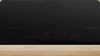 A close-up shot of a black induction hob with red digital displays. Produktbild-Vorschau