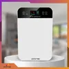 A white air purifier is displayed on a white pedestal against a blurred background. Podgląd zdjęcia produktu