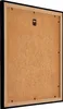 The back of a black picture frame with a brown backing board. Produktbild-Vorschau