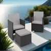 Two rattan chairs with cushions and an ottoman are placed on a patio overlooking the ocean. Voir les images du produit