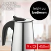 Close-up of a stainless steel coffee maker with a black handle, with blurred background. Produktbild-Vorschau