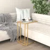 A modern living room scene with a couch, blanket, pillow, and a glass-top side table. Produktbild-Vorschau