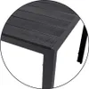 A close-up view of the corner of a dark-colored outdoor table, showing the texture of the tabletop and the metal frame. Produktbild-Vorschau