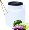 A white plastic barrel with a black lid and handles, shown with tongs and various cabbages. Produktbild-Vorschau