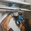 A person is using a cordless reciprocating saw to cut a pipe mounted on a wall. Anteprima dell’immagine prodotto