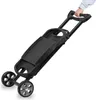 A person's hand is holding the handle of a black, foldable grill cart. Anteprima dell’immagine prodotto