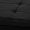 A close-up view of the tufted fabric surface of a black ottoman or bench. Náhled obrázku produktu