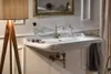 A bathroom sink with a bronze faucet and accessories. Anteprima dell’immagine prodotto