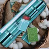 A collection of mini books arranged in a basket, with cotton balls scattered around. Náhled obrázku produktu