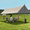 Two people are sitting at a table under a large canopy, enjoying a picnic or camping trip. Produktbild-Vorschau