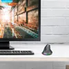 A vertical wireless gaming mouse with RGB lighting sits on a desk next to a keyboard and a computer monitor displaying a futuristic cityscape. Produktbild-Vorschau