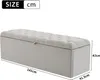A light gray upholstered storage bench with tufted detailing, shown with dimensions indicated. Voir les images du produit