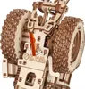 A close-up view of a wooden model tractor's wheel and mechanical components. Náhľad obrázku produktu