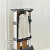 A garment steamer with a white shirt and brown pants hanging on it. Produktbild-Vorschau