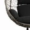 A close-up view of a hanging chair with black cushions. Produktbild-Vorschau